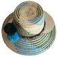 "Colorful handmade Wayuu hat woven from Iraca palm fibers, featuring decorative pompoms and offering adjustable fit."