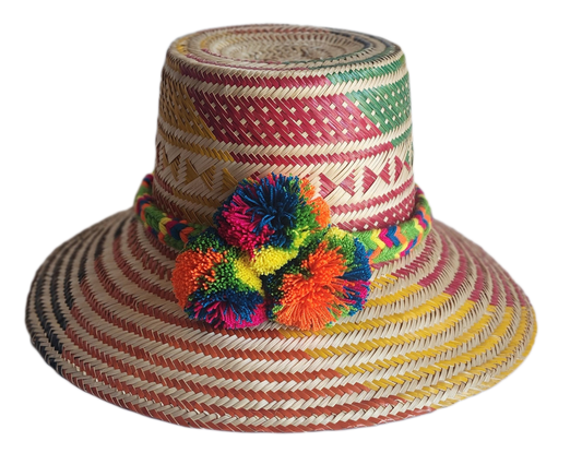 "Colorful handmade Wayuu hat woven from Iraca palm with adjustable fit and cultural pompoms, supporting Wayuu artisans."