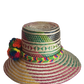 "Colorful handmade Wayuu hat woven from Iraca palm with adjustable fit and cultural pompoms, supporting Wayuu artisans."