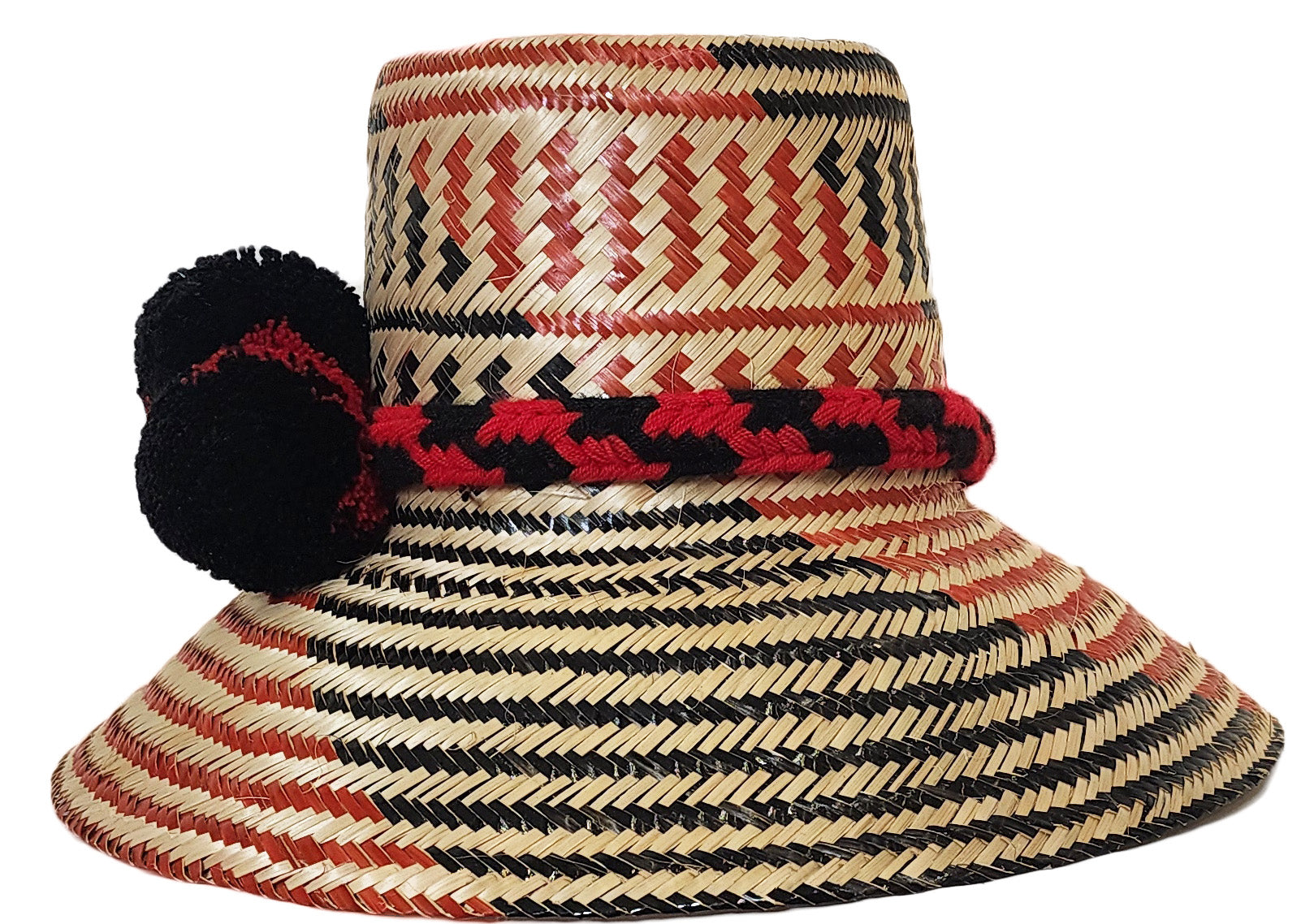 "Colorful handmade Wayuu hats from Wuitusu, crafted with Iraca palm fibers, featuring decorative pompoms."