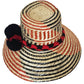 "Colorful handmade Wayuu hats from Wuitusu, crafted with Iraca palm fibers, featuring decorative pompoms."