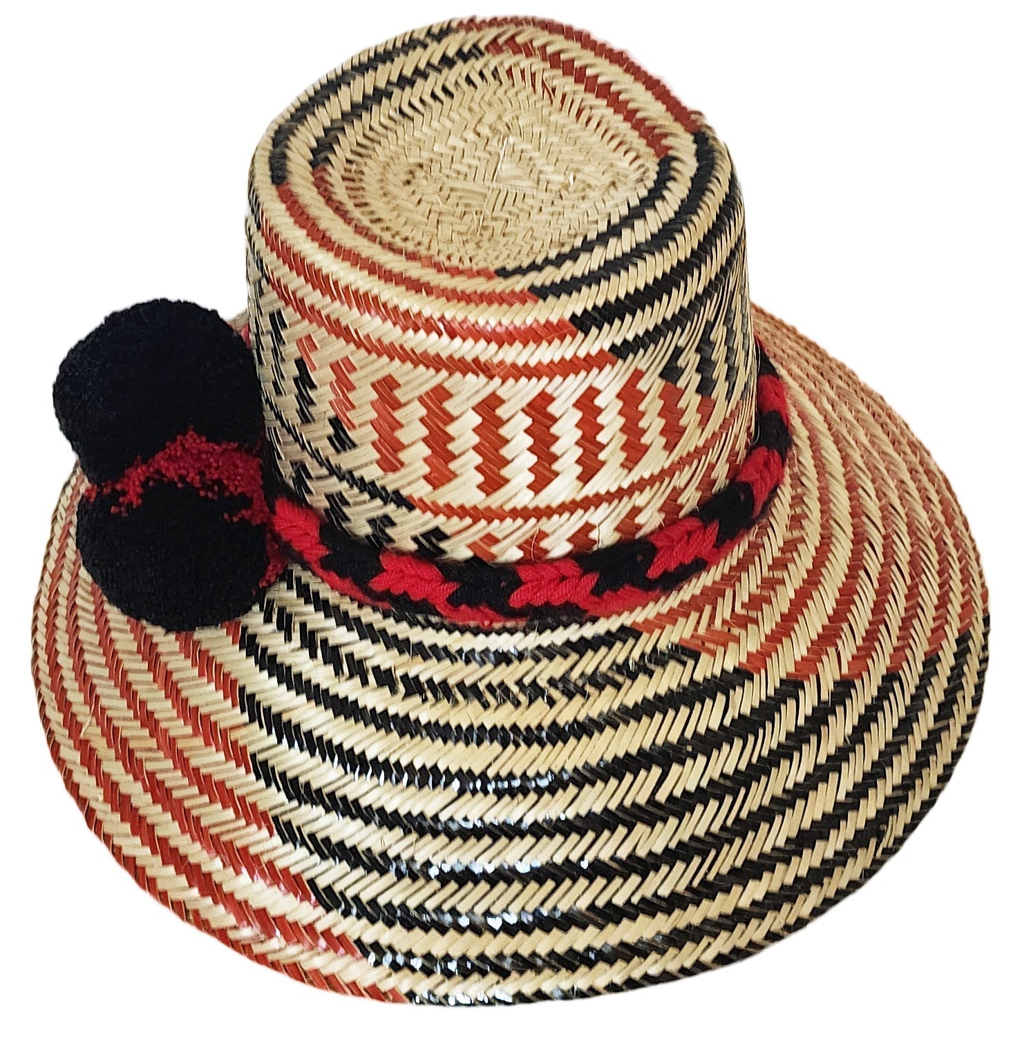 "Colorful handmade Wayuu hats from Wuitusu, crafted with Iraca palm fibers, featuring decorative pompoms."
