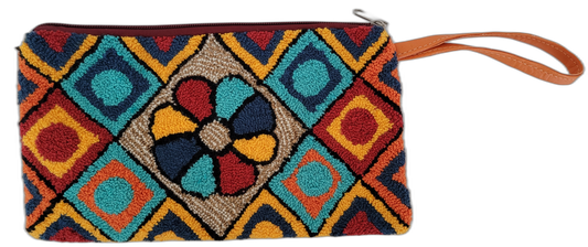 Colorful Boho crochet clutch with floral and geometric punch needle patterns, handcrafted by Wayuu artisans.