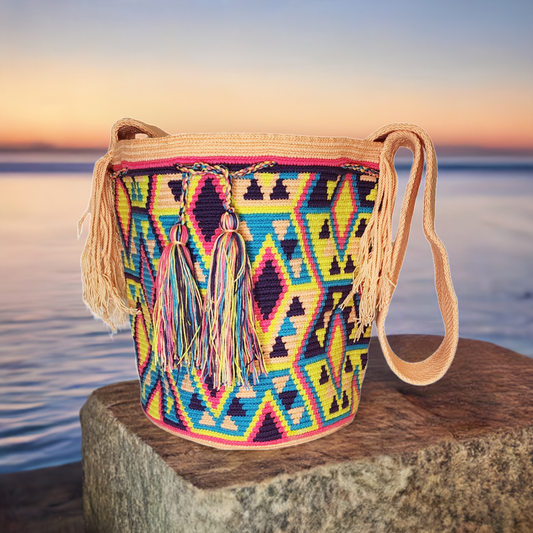 "Colorful handmade Wuitusu crochet Wayuu bag, showcasing traditional geometric patterns and a long woven strap for versatile 