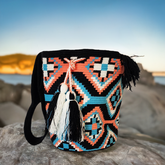 "Colorful handmade Wuitusu Wayuu crochet bag by Colombian and Venezuelan artisans, featuring bold boho patterns and a long st