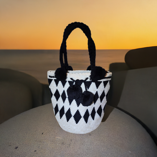 "Colorful handmade Wuitusu Wayuu crochet bag with short handle, celebrating traditional artistry and supporting fair trade."