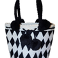 "Colorful handmade Wuitusu Wayuu crochet bag with short handle, celebrating traditional artistry and supporting fair trade."