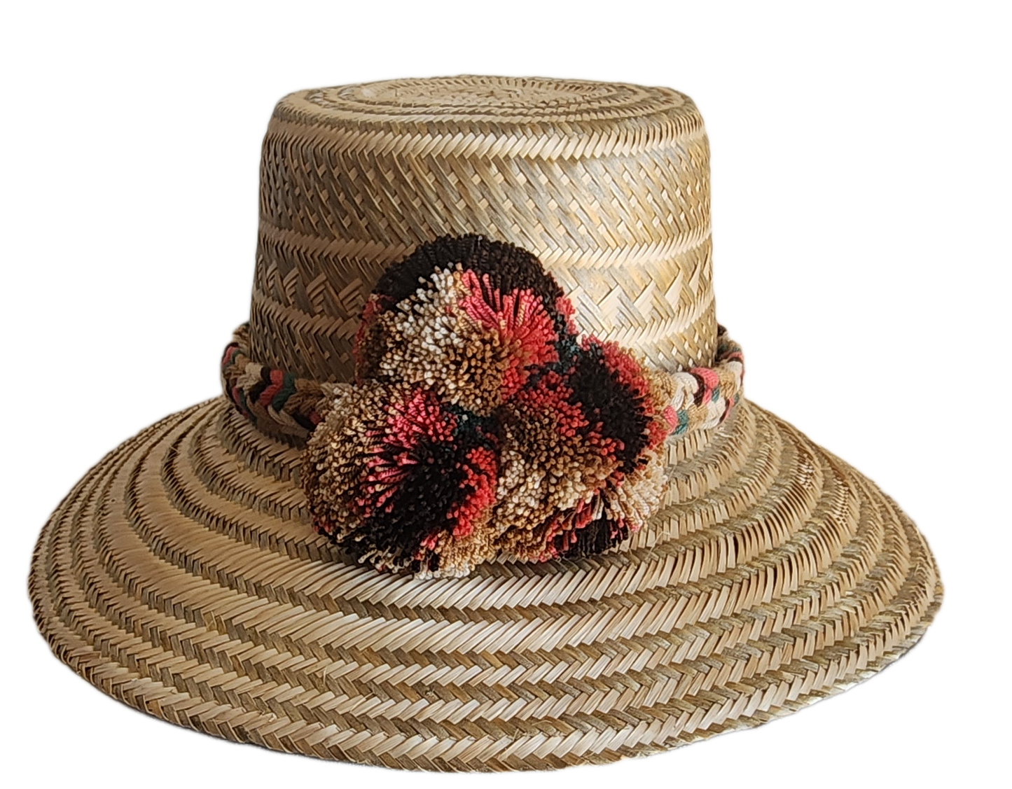 "Colorful handmade Wuitusu Wayuu hat crafted from Iraca palm fibers, adorned with culturally significant pompoms."