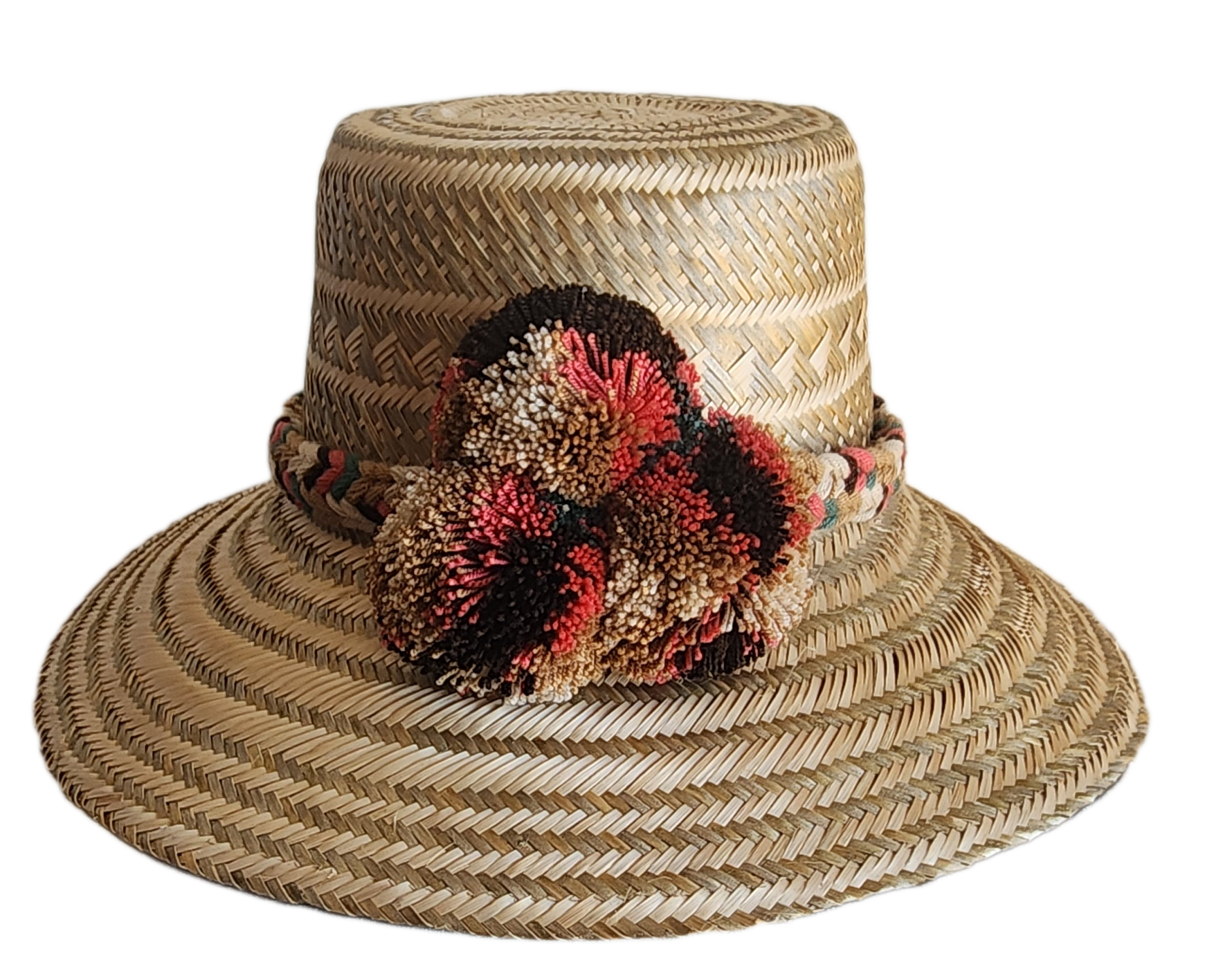 "Colorful handmade Wuitusu Wayuu hat crafted from Iraca palm fibers, adorned with culturally significant pompoms."