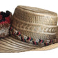 "Colorful handmade Wuitusu Wayuu hat crafted from Iraca palm fibers, adorned with culturally significant pompoms."