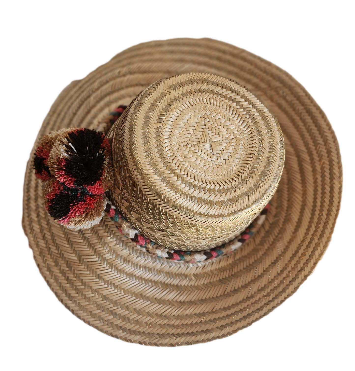 "Colorful handmade Wuitusu Wayuu hat crafted from Iraca palm fibers, adorned with culturally significant pompoms."