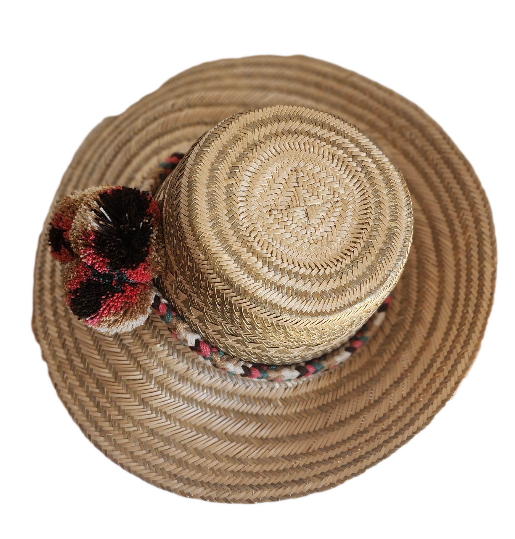 "Colorful handmade Wuitusu Wayuu hat crafted from Iraca palm fibers, adorned with culturally significant pompoms."
