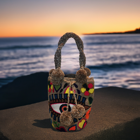 "Colorful handmade Wuitusu Wayuu punch needle crochet bag, featuring intricate patterns and a bohemian crossbody design."