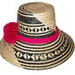 "Colorful handwoven Wayuu hat from Wuitusu, crafted with Iraca palm fibers and decorated with cultural pompoms."