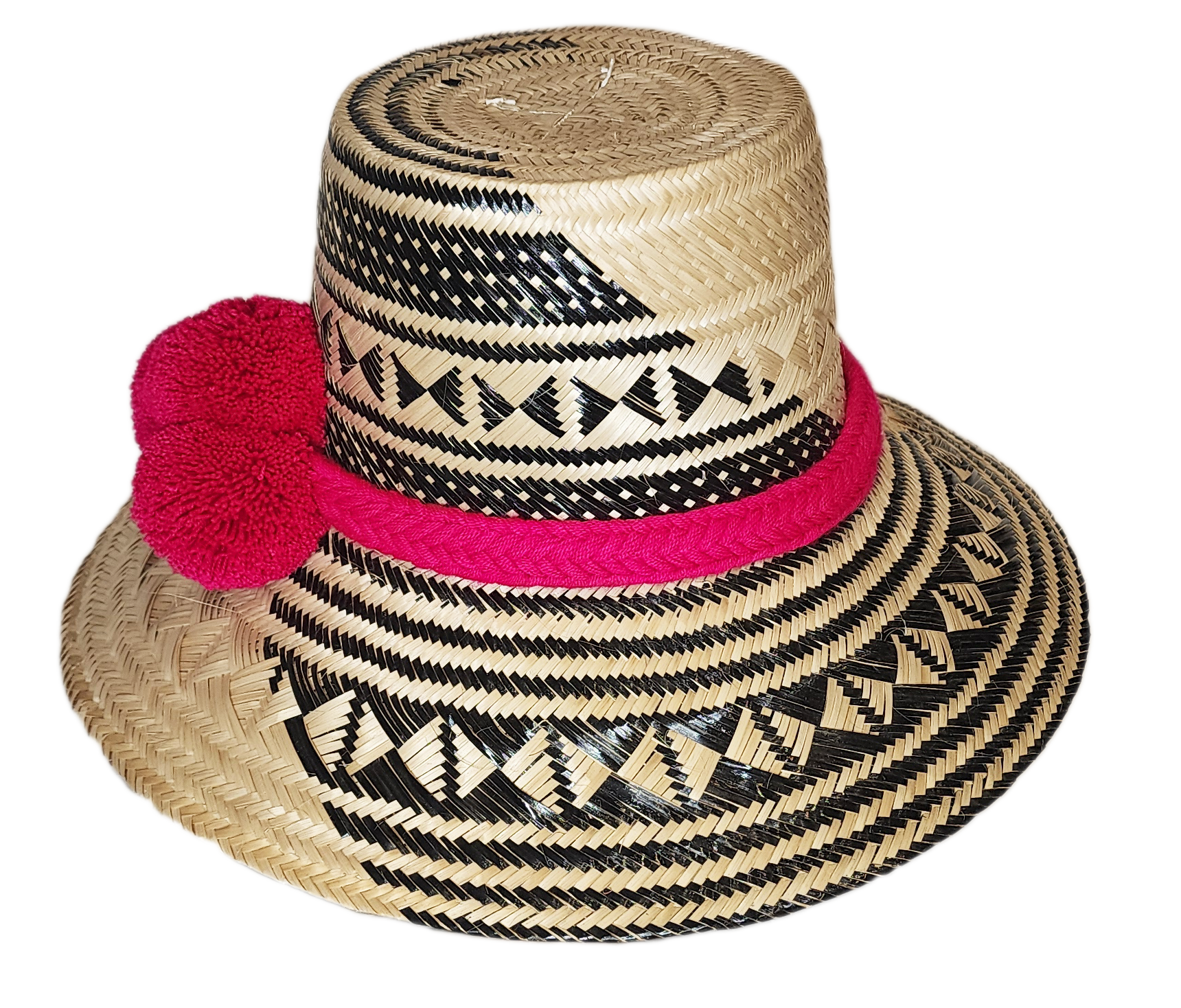 "Colorful handwoven Wayuu hat from Wuitusu, crafted with Iraca palm fibers and decorated with cultural pompoms."