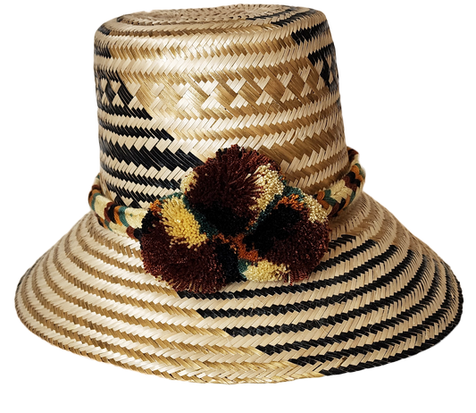 "Colorful handwoven Wayuu hat made from Iraca palm, adorned with cultural pompoms for prosperity, adjustable to fit all sizes