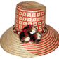 "Colorful handwoven Wayuu hat made from Iraca palm fibers, adorned with cultural pompoms, offering versatile and stylish sun 