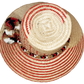 "Colorful handwoven Wayuu hat made from Iraca palm fibers, adorned with cultural pompoms, offering versatile and stylish sun 