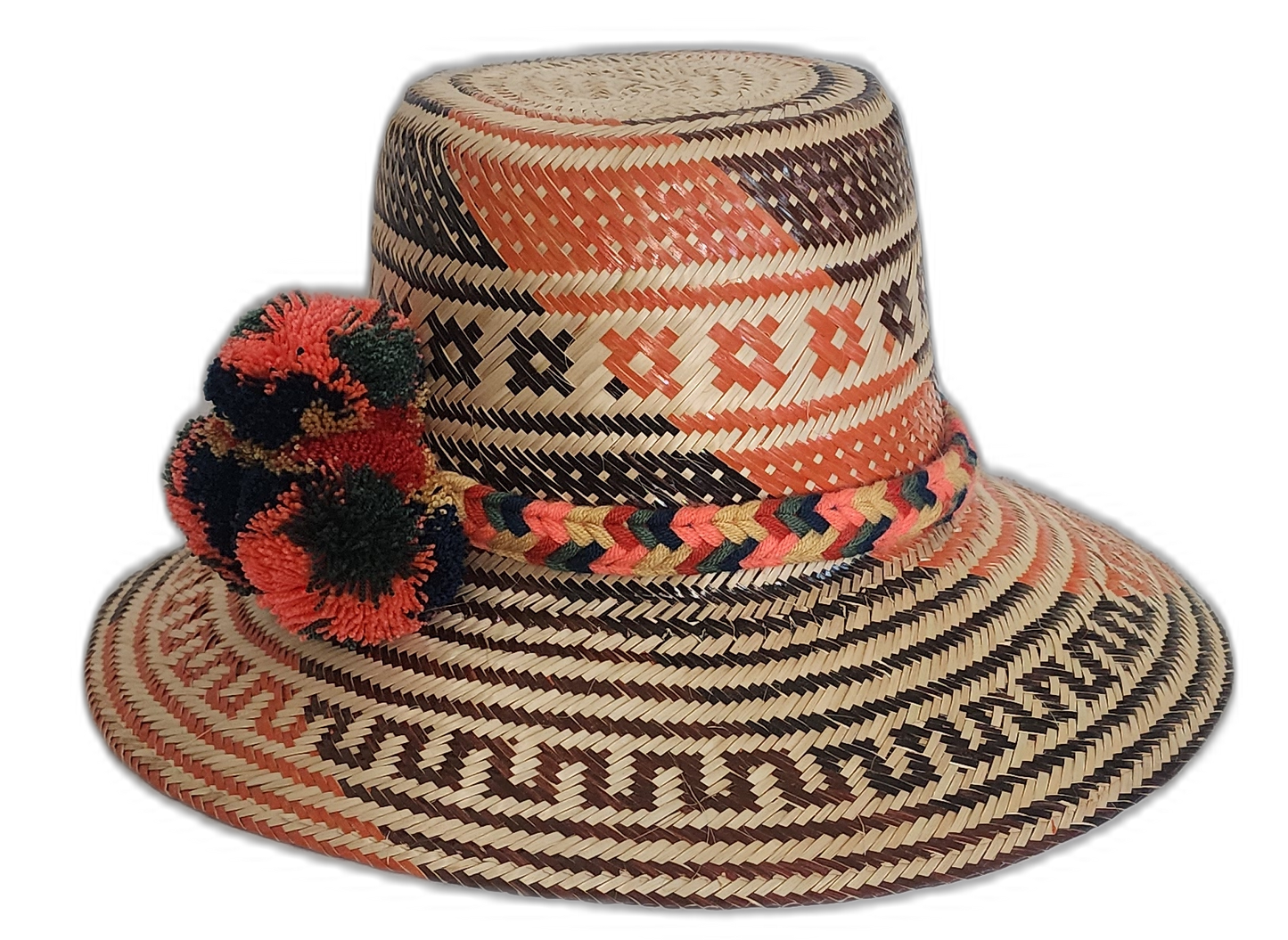 Artisan boho straw hat in natural straw with red and black patterns and colorful pompoms.