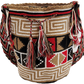 Bohemian crochet bag, handmade by Wayuu artisans, featuring bold red, black, and tan weave, geometric patterns, wide strap, and large tassels.