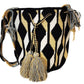 Bohemian crochet bag, handmade by Wayuu artisans, featuring black, tan, and white geometric waves, sturdy strap, and oversized tassels.
