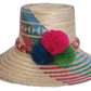 Handmade Wayuu straw hat with red, blue, and green pompoms and vibrant multicolor weave.


