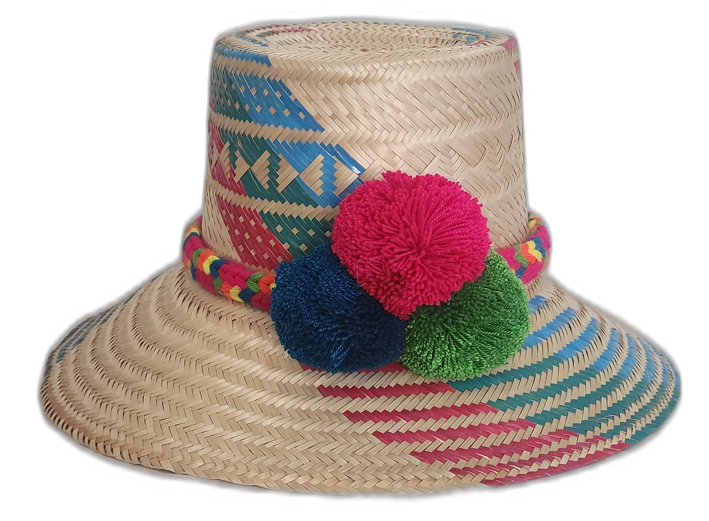 Handmade Wayuu straw hat with red, blue, and green pompoms and vibrant multicolor weave.


