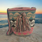 Colorful boho Wayuu crochet bag with tassels and geometric patterns, handmade by Wayuu artisans.