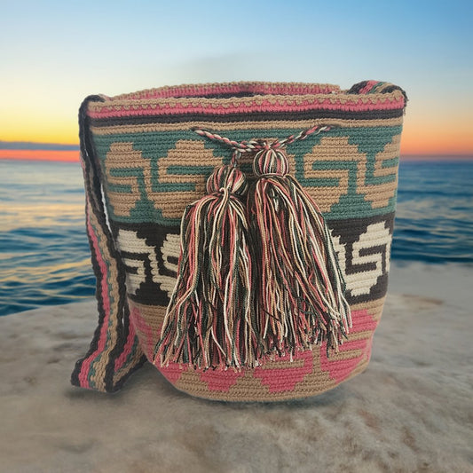 Colorful boho Wayuu crochet bag with tassels and geometric patterns, handmade by Wayuu artisans.
