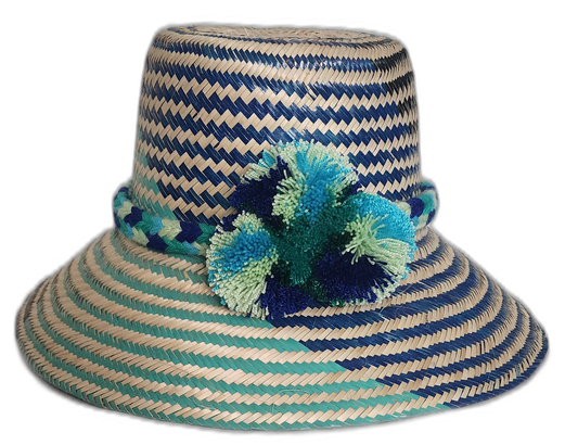 Handmade bohemian straw hat with blue and green pompoms by Wayuu artisans