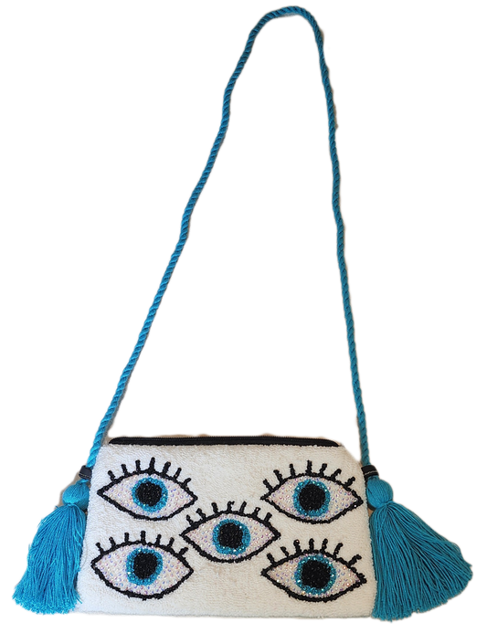 "Colorful Wayuu clutch with intricate crochet patterns and crystal embellishments, handcrafted by the Wuitusu collective."