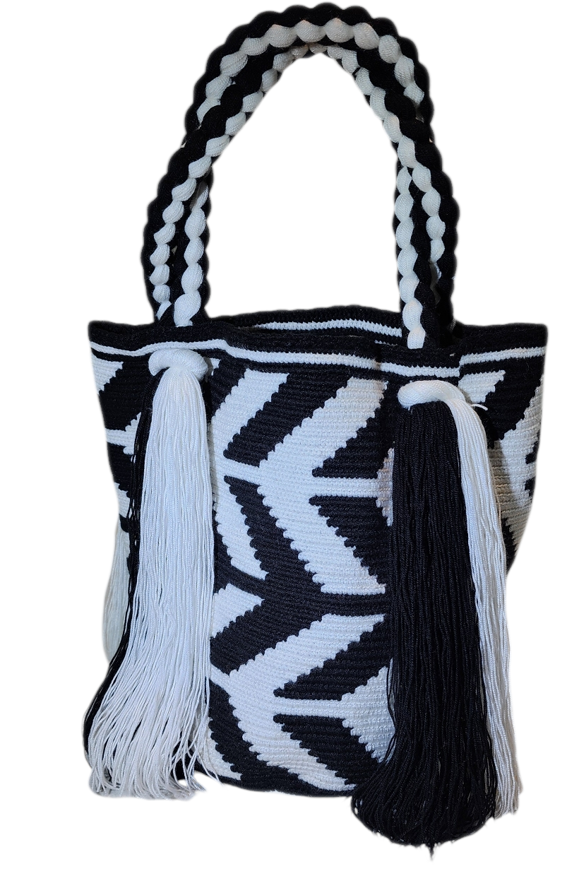 Bohemian crochet handbag, handmade by Wayuu artisans, featuring black-and-white geometric zigzag design, thick braided handles, and long tassels.