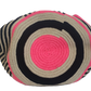 Colorful Wayuu crochet bag with bold pink and black contrast, artisan tassels, and wide strap — a must-have boho-chic accessory.