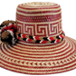 "Colorful Wayuu hat, handwoven from Iraca palm fibers by artisans, adorned with meaningful pompoms for style and cultural sig