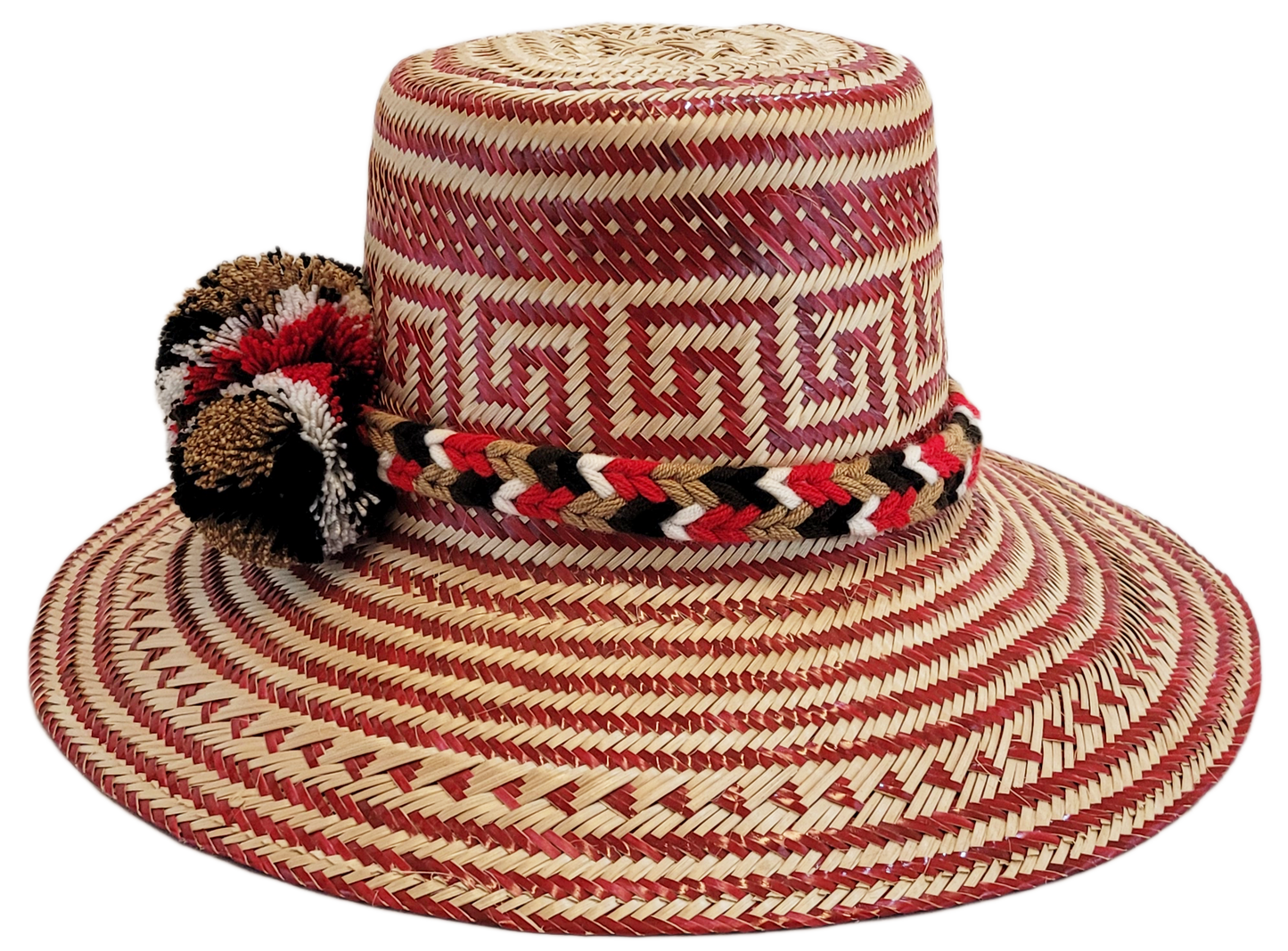 "Colorful Wayuu hat, handwoven from Iraca palm fibers by artisans, adorned with meaningful pompoms for style and cultural sig