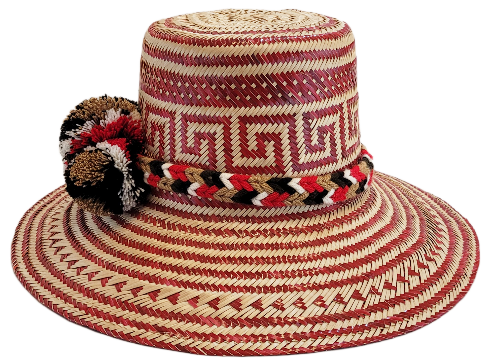 "Colorful Wayuu hat, handwoven from Iraca palm fibers by artisans, adorned with meaningful pompoms for style and cultural sig