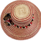 "Colorful Wayuu hat, handwoven from Iraca palm fibers by artisans, adorned with meaningful pompoms for style and cultural sig