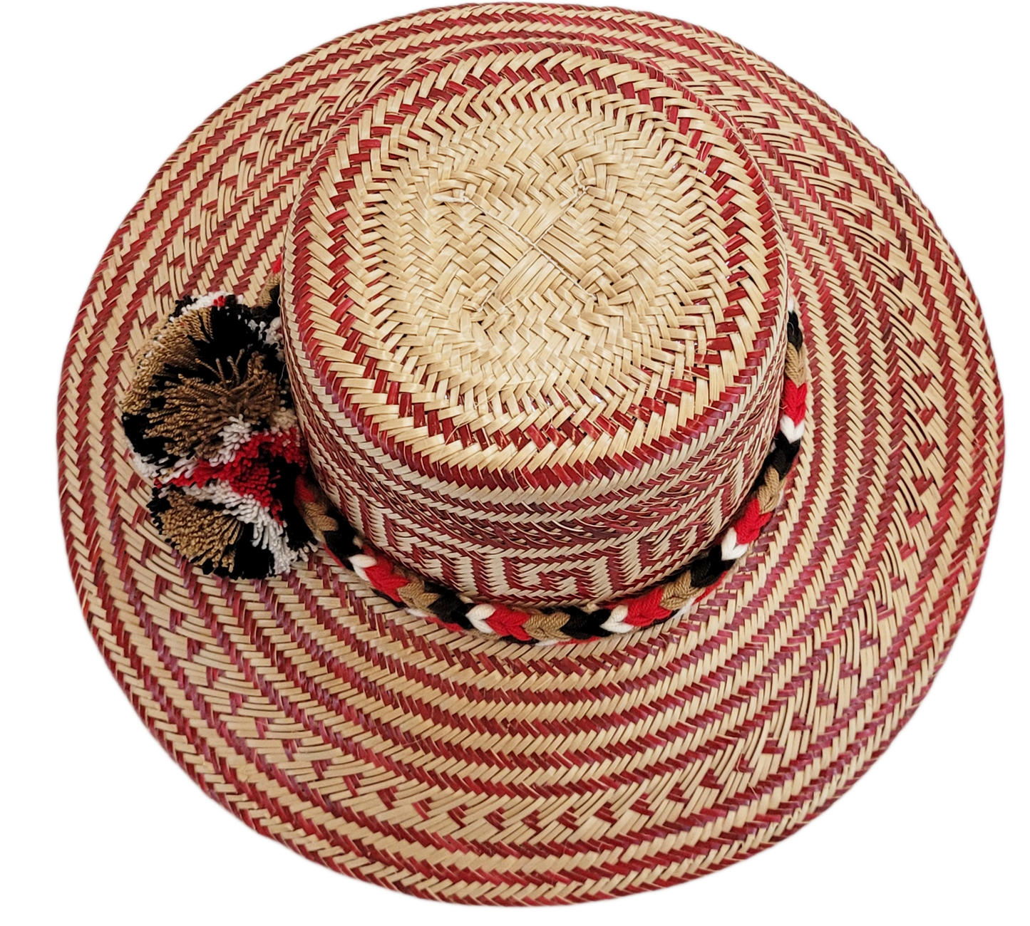 "Colorful Wayuu hat, handwoven from Iraca palm fibers by artisans, adorned with meaningful pompoms for style and cultural sig