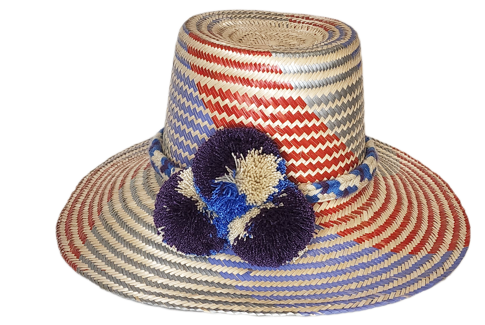 "Colorful Wuitusu Wayuu hat crafted from Iraca palm fibers, adorned with significant pompoms, versatile and adjustable fit."