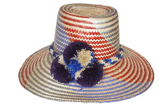 "Colorful Wuitusu Wayuu hat crafted from Iraca palm fibers, adorned with significant pompoms, versatile and adjustable fit."