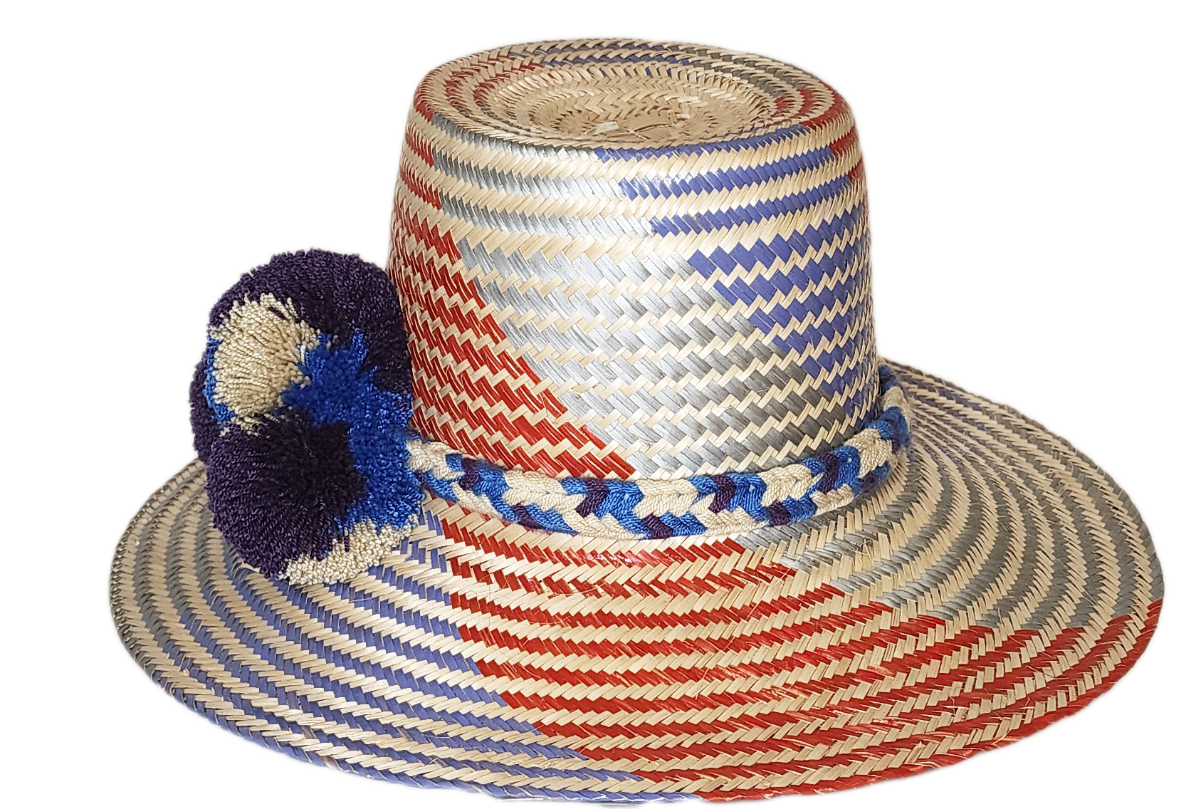 "Colorful Wuitusu Wayuu hat crafted from Iraca palm fibers, adorned with significant pompoms, versatile and adjustable fit."
