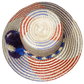 "Colorful Wuitusu Wayuu hat crafted from Iraca palm fibers, adorned with significant pompoms, versatile and adjustable fit."