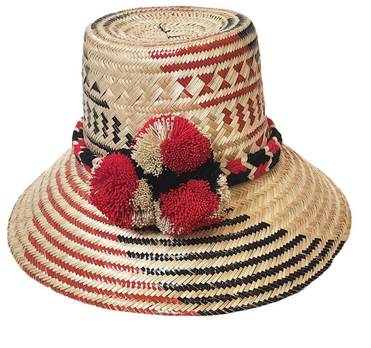 "Colorful Wuitusu Wayuu hat handwoven from Iraca palm fibers, featuring adjustable brim and decorative pompoms for sun protec