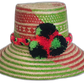 Vibrant red and green Boho straw hat handmade by Wayuu artisans