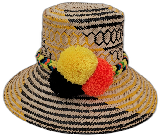 Daniela handmade Wayuu straw hat with yellow and black palm weave and vibrant pompoms

