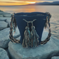 Dark blue handmade Wayuu crochet bag with turquoise tassels and a Boho chevron strap — artisan and bold.