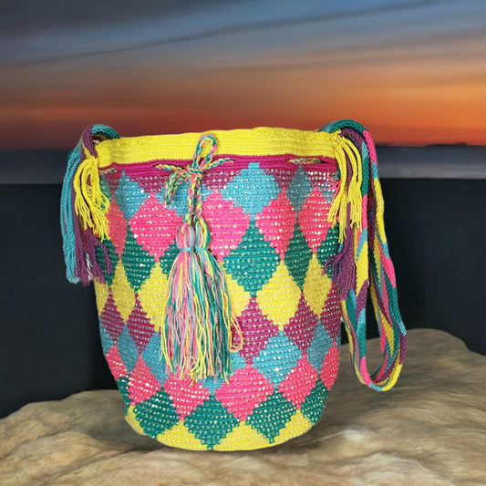Handmade Wayuu crochet bag with multicolor diamond patterns and tassels.