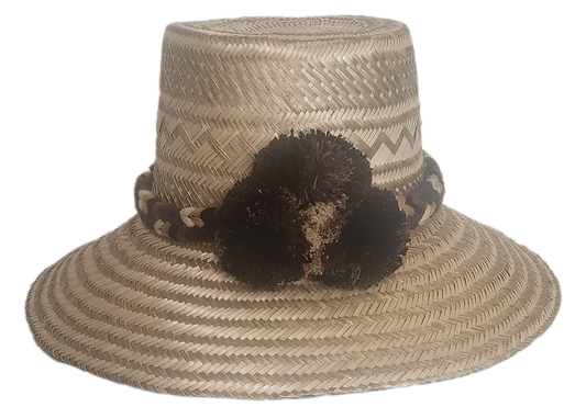 Handmade boho straw hat with earth-toned pompoms and zigzag woven pattern
