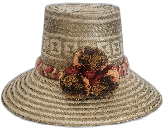 Handmade Wayuu straw hat in earthy tones with brown and orange pompoms