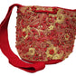 Red and gold Wayuu boho crochet bag with oversized tassels and artisan strap.